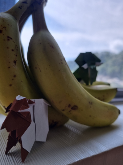 Origami sheep and elephant pictured with banana